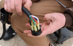 A person holding 7 way trailer wiring.