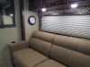 Camco RV wall clock mounted in an RV living room.