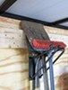 Rackem shovel rack holding shovel inside enclosed trailer. 
