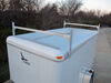 White enclosed trailer with roof rack.