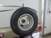 Roadmaster spare tire carrier holding tire mounted to RV.