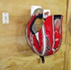 Tow-rax helemt hanger holding red motorcycle helmet. 