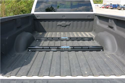 Above-bed fifth wheel rail system in pickup truck bed