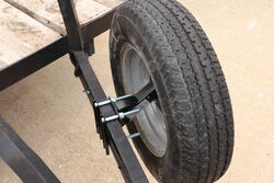 Black Flint Hill Goods Spare Tire Carrier mounted to a trailer frame holding a spare tire 