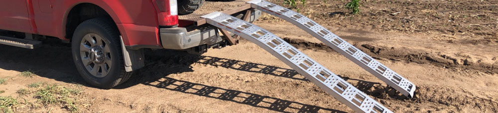 Loading ramps attached to truck bed.