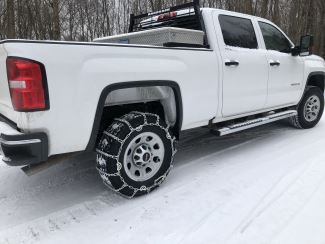 Tire Chains on White Truck in Snow