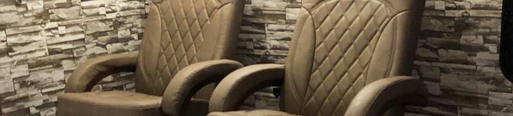 Thomas Payne tan swivel recliners.