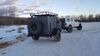 White Jeep pulling teardrop camper in the winter.