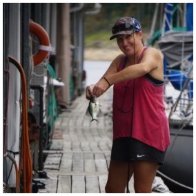 Kim catching a fish on the dock.