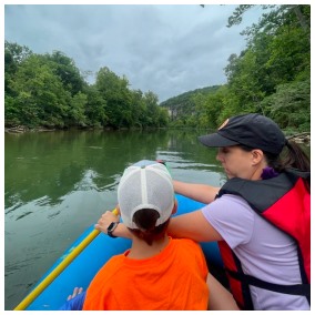 Nicki and child floating on the river.