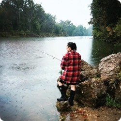 woman fishing in rain. 
