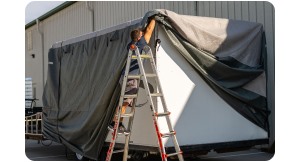 man putting cover on RV. 