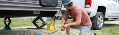 man cranking scissor jack