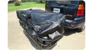 Bag on hitch cargo carrier attached to black suv.