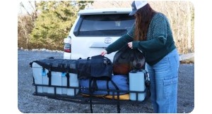 woman loading hitch cargo carrier. 