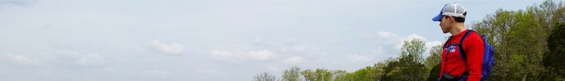 man looking out over a cliff. 