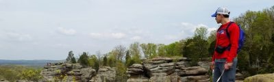 Man looking out over a cliff. 
